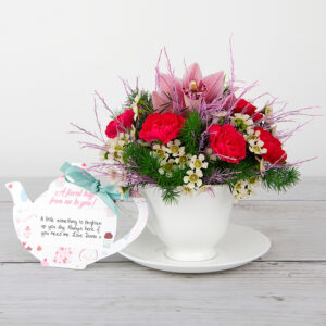 Pink Orchid, Spray Carnations, White Waxflower and Tree Fern inside Bone China Teacup